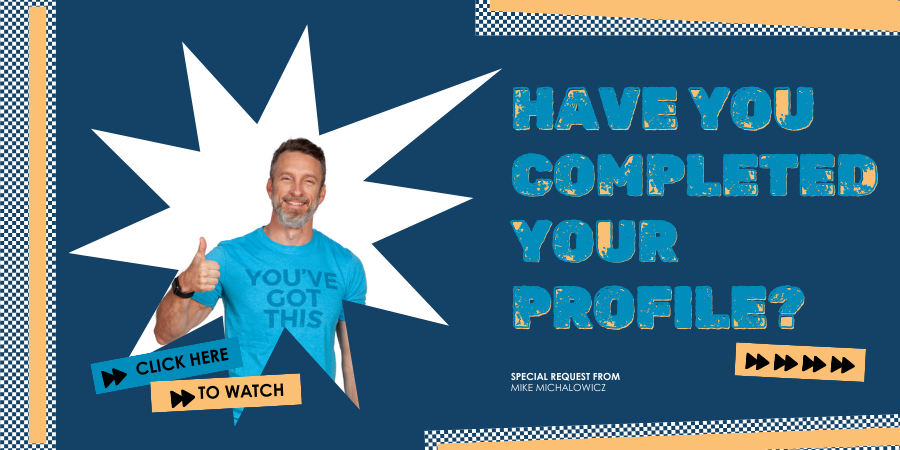 Man in a blue shirt gives a thumbs-up next to the text "Have You Completed Your Profile?" and "Click Here To Watch," featuring a starburst graphic background.