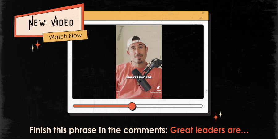 A person wearing a red shirt and a white cap is speaking into a microphone on a video player screen, with the text "GREAT LEADERS" visible. The text prompts viewers to finish the phrase "Great leaders are…" in the comments.