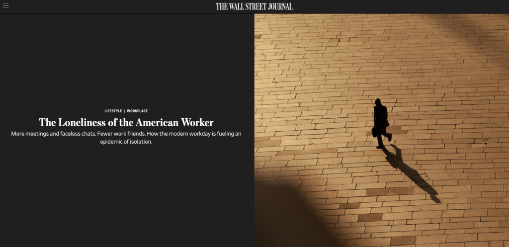 A person walks alone across a large, sunlit plaza. An article titled "The Loneliness of the American Worker" is displayed on the left side of the image, published by The Wall Street Journal.